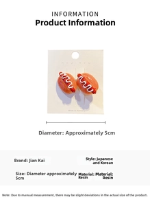 Detail showing creative hot dog shaped resin hair clip on a branded nyunyu display card