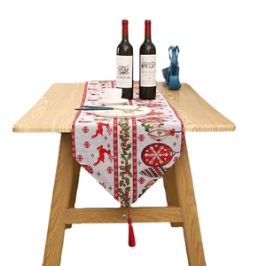 Christmas table runner with red reindeer patterns and white knitted fabric textures