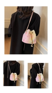 Detail showing the plush macaron gradient bucket bag with pearl drawstring and chain strap