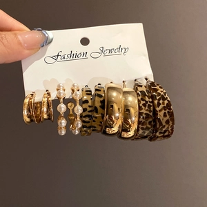 5-pair set of gold C-shaped earrings with leopard print and pearl bead accents