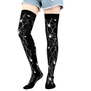 Detailed view of Halloween themed black over-the-knee socks with white spider web print