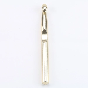 Close-up of golden aluminum crochet hook with 6.00mm size engraving on a white background