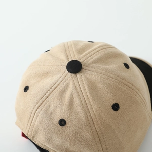 Detailed view of khaki faux suede baseball cap top with black ventilation eyelets