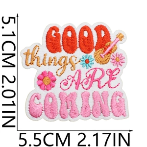 Detail of GOOD THINGS ARE COMING embroidered patch with guitar and flower motifs