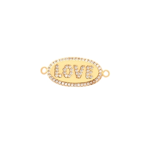Macro shot of gold oval charm with rhinestone LOVE lettering and sparkling crystal border
