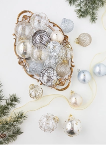 Exquisite Christmas ball ornaments with gold patterns in a vintage carved metal tray