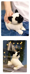 Close-up of a soft cream pug plush toy with black ears on a blue checkered blanket