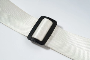 Close-up of durable white nylon strap with black adjustable plastic buckle on waist bag