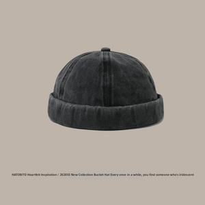 Close-up of vintage washed denim docker hat showing texture and six-panel stitching details