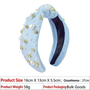 Detail of light blue knotted headband with white pearls and sparkling crystal rhinestones