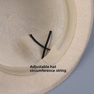 Detail of breathable knit hat interior featuring adjustable black drawstring and sweatband
