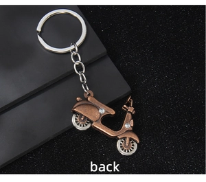 Back view of a vintage bronze scooter motorcycle keychain with metal ring and chain