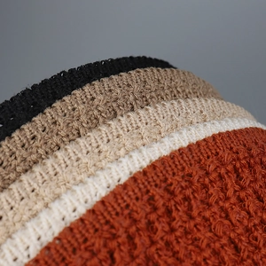 Detail view showing textured crochet knit patterns and various colors of sun hats