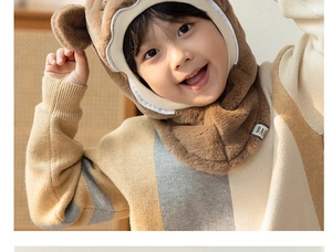 Close-up of brown plush bear ears on children's integrated winter warm hooded scarf