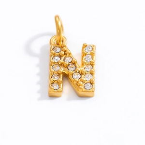 Macro view of gold plated 18K letter N pendant with sparkling zircon stones