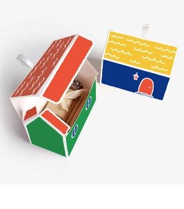 Detail of colorful house-shaped gift boxes with white ribbon handles on white background