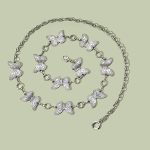 Detail of silver chain belt featuring ten hollow butterfly pendants and lobster clasp