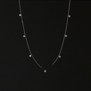 Detail view of silver titanium steel necklace featuring seven sparkling zircon pendants