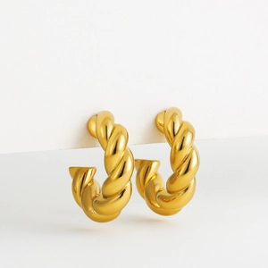 Close-up of 18K gold plated C-shaped twisted rope hoop earrings with high polish texture