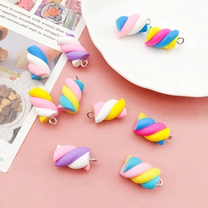 Colorful resin marshmallow charms for DIY jewelry making displayed on pink background