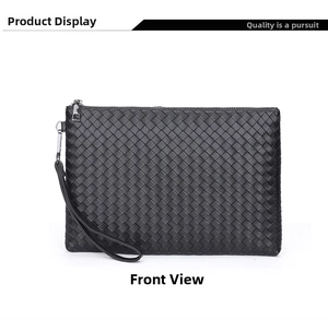 Detail of woven black leather clutch with silver zipper and detachable wrist strap