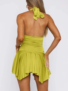 Detailed back view of lime green halter dress featuring lace-up straps and pleated waist