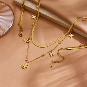 Double-layered gold stainless steel necklace with clover flower and ring pendants