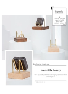 Close-up of walnut wood base and brass U-shaped stand for crystal and mineral display