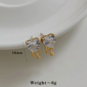Detail of gold heart stud earrings with zircons measuring 16mm and weighing 6g