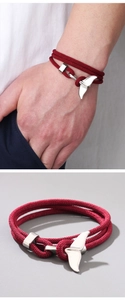 Nautical style multi-layer braided red bracelet with silver whale tail charm detail