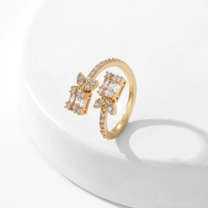 Macro shot of gold plated open ring featuring baguette and round cubic zirconia inlay