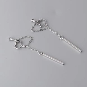 Detail view of silver lightning bolt clip earrings with chains and purple zircons