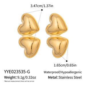 Detail view of double heart earrings in gold plated stainless steel showing size and weight