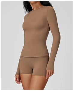 Slim fit brown yoga set featuring long sleeve crewneck top and matching cycling shorts