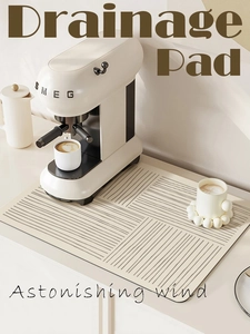Detail view of a minimalist kitchen drainage pad with gray geometric patterns on beige
