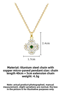 Detailed view of gold clover necklace with green gemstone and 40cm titanium chain