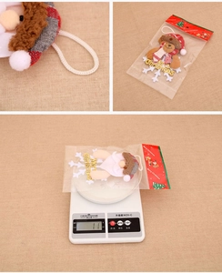 Detailed view of Christmas plush ornaments showing weight on scale and packaging details