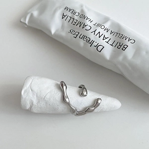 Macro detail of high-polished 925 sterling silver liquid ring on white cone stand