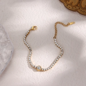 Detail of gold zircon bracelet with K18 tag and adjustable lobster clasp closure