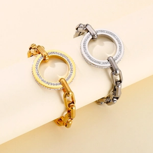 Detailed view of gold and silver chunky chain bracelets with crystal encrusted circles