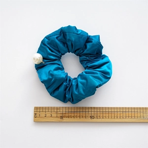 Peacock blue satin scrunchie with large white pearl charm and 14cm measurement scale