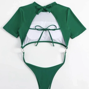 Dark green backless one-piece swimsuit with high-cut design and metal ring details