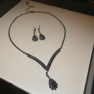 Macro view of French vintage jewelry set featuring black pear-cut crystal tassels