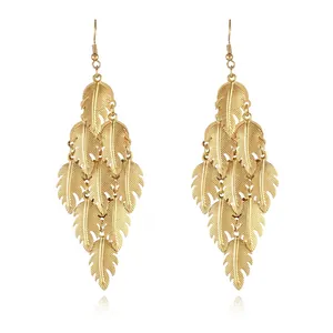 Detail of 18k gold plated layered leaf tassels earrings with fine textured feathers