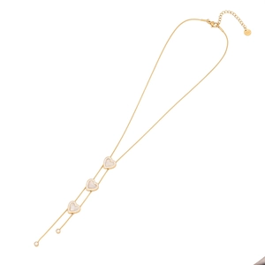 Detail of gold Y-necklace with heart pendants and S.STEEL stamp on stainless steel