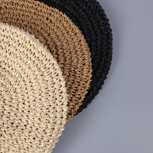 Macro detail of handmade crochet raffia weave in beige, brown, and black textures