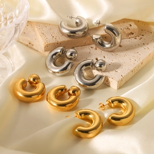 Minimalist C-shape hollow earrings in gold and silver finish on silk background