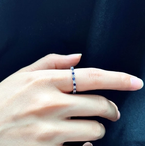 Detail of S925 sterling silver ring featuring alternating blue sapphires and white diamonds