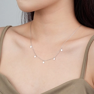 S925 Sterling Silver necklace with five minimalist round discs shown on model neck