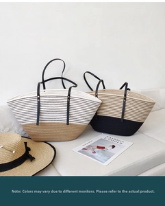 Detail of hand-woven tote bag with leather handles and gold studs on a sofa